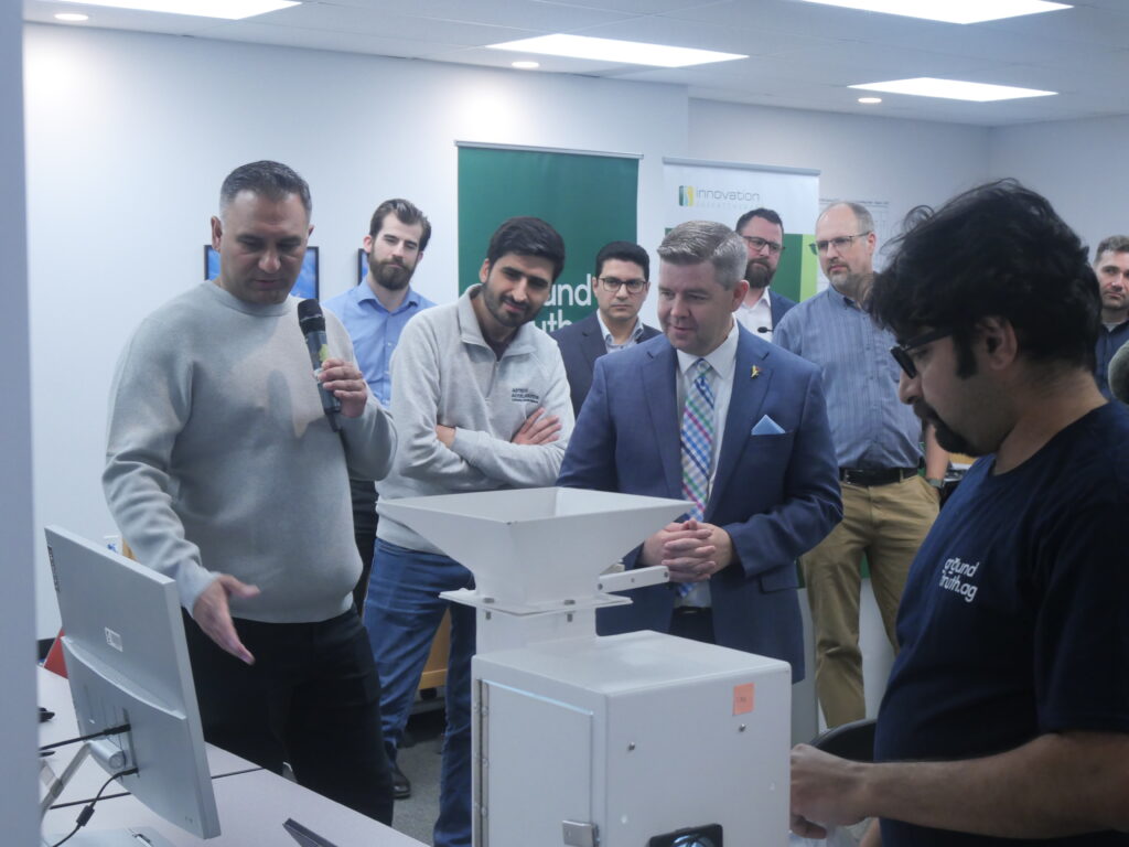 Group of individuals at Ground Truth Technology observing a demo of the company's technology, featuring Minister Jeremy Harrison.